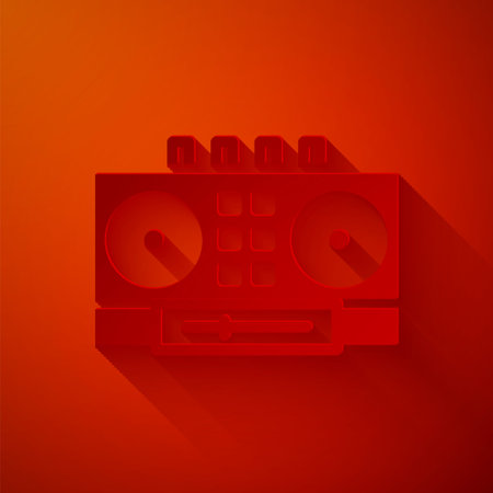 Paper cut DJ remote for playing and mixing music icon isolated on red background. DJ mixer complete with vinyl player and remote control. Paper art style. Vectorのイラスト素材