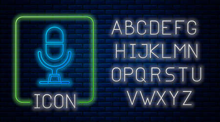 Glowing neon Microphone voice device icon isolated on brick wall background. Microphone interpreter and alphabet letters. Neon light alphabet. Vectorのイラスト素材