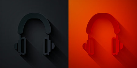 Paper cut Headphones icon isolated on black and red background. Earphones. Concept for listening to music, service, communication and operator. Paper art style. Vectorのイラスト素材
