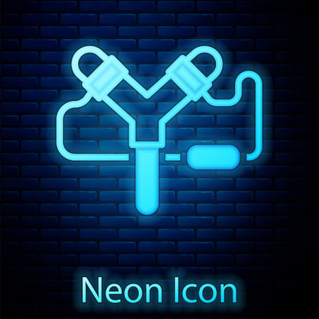 Glowing neon Slingshot icon isolated on brick wall background. Vectorのイラスト素材