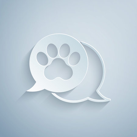 Paper cut Paw print icon isolated on grey background. Dog or cat paw print. Animal track. Paper art style. Vectorのイラスト素材