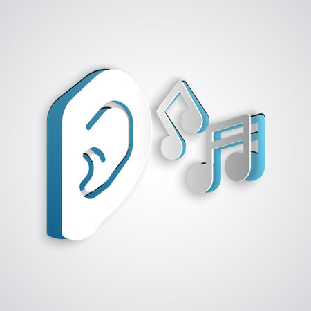 Paper cut Ear listen sound signal icon isolated on grey background. Ear hearing. Paper art style. Vectorのイラスト素材