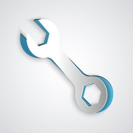 Paper cut Wrench spanner icon isolated on grey background. Paper art style. Vectorのイラスト素材