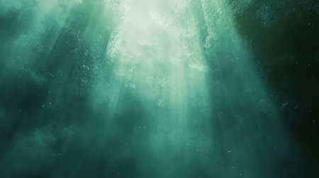 Light rays penetrating mysterious dark teal deep watersの写真素材