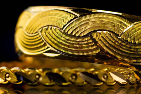 Macro gold bangle Jewelery on black background, Traditional indian gold bangles