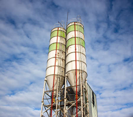 Cement mixing silo of concrete batching plant with blue skyの写真素材