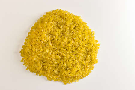 Bulgur wheat, heap of dry uncooked Bulgur wheat grains on white background, top viewの写真素材