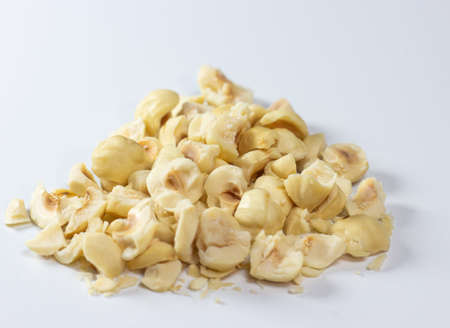Heap of chopped hazelnut, Pile of diced or crushed, peeled and roasted hazelnut isolated on white...