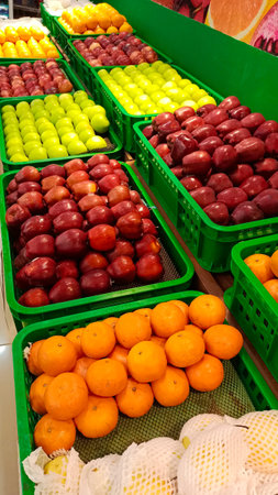 Fresh fruits in basket on farm market shelf, apple and orange fruits.の写真素材