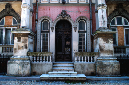 Facade with columns of an old dilapidated building in the city center.の写真素材