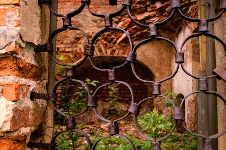 Part of the old forged bars on the window of the church.の写真素材