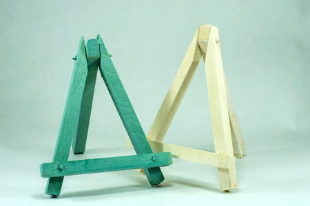 Blue and white wooden mini easels on a light background.の写真素材