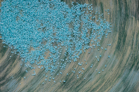 Blue scattered gravel and swirling streams dark background handmade.の写真素材