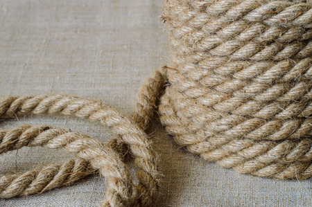 Hemp rope folded high and on a linen background.の写真素材