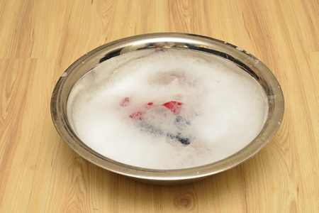 basin with white  foam on wooden floorの写真素材