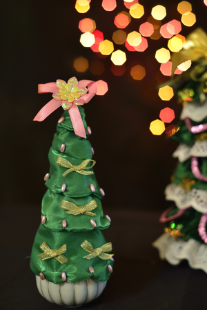 small decorative new year tree over bokeh backgroundの写真素材