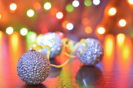 silver Christmas ball on wooden surface with serpentine