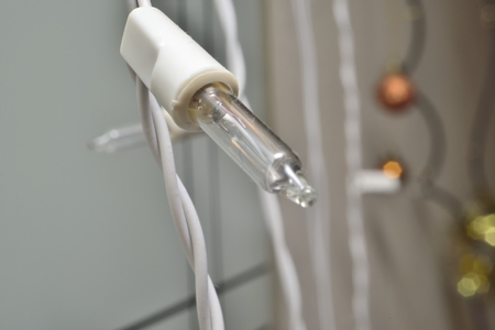 macro zoomed diode lamp on white wireの写真素材