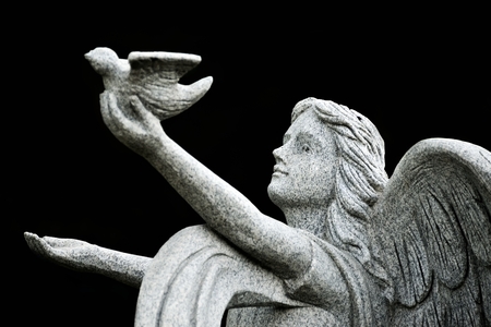 stone marble Angel praying for peace near churchの写真素材