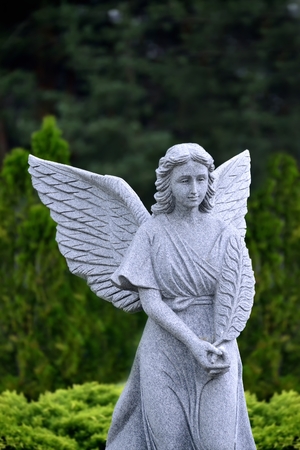 Christian stone marble Angel in forest  near churchの写真素材