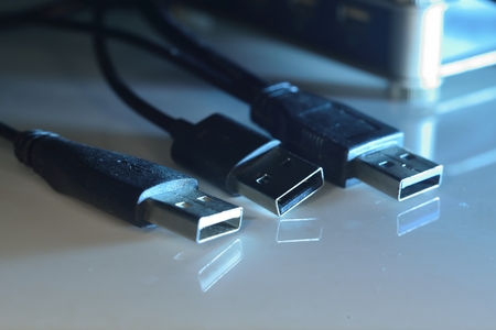 colorful macro zoomed usb connectors on wire on mirror surface