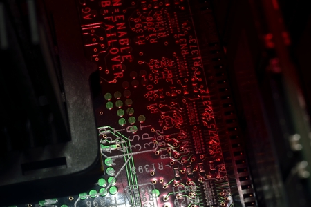 dark abstract red and green microcircuit (technology background)