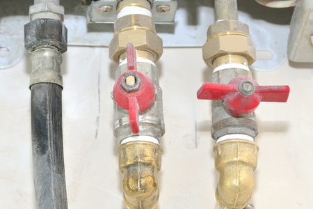 gas and water pipes with cranes, taps, faucet for water heatingの写真素材