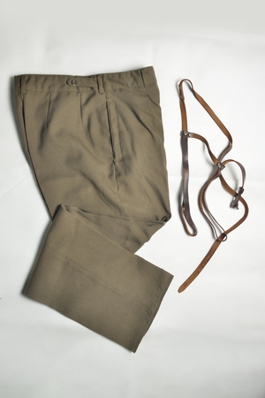 brown old-fashioned men's trousers (pants) with braces over whiteの写真素材
