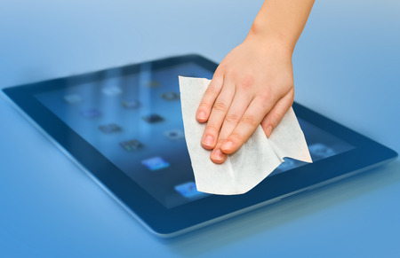 hand with white wet wipe tablet cleaningの写真素材
