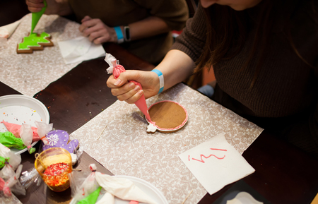 hands with cream for cookies (DIY handmade sweets)の写真素材