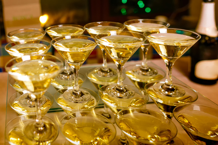 conical cocktail glasses with white wineの写真素材