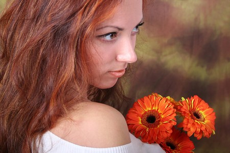 beautiful young girl with bunch of flowersの写真素材