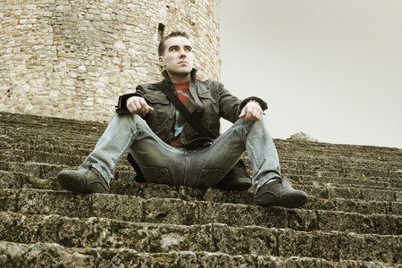 young guy sitting on stairsの写真素材