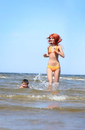 young mother and son having fun on the beachの写真素材
