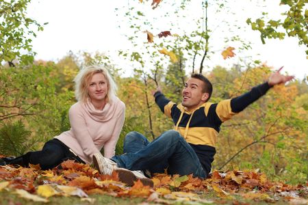 beautiful couple having fun in autumn parkの写真素材