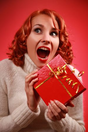 funny redhead woman with bright red presentの写真素材