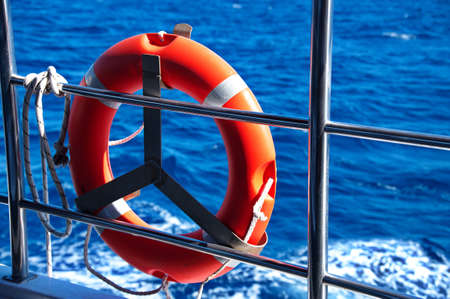 Life vest on the fence of the ship against blue sea