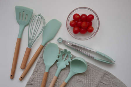 Set of kitchen utensils and cherry tomato on white background - directly aboveの写真素材