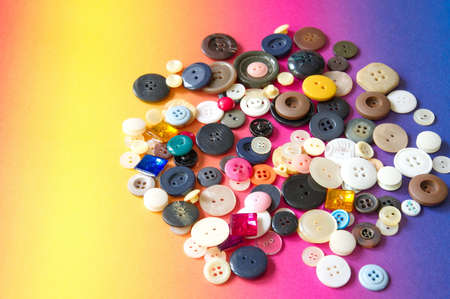 Flat lay of sewing buttons on colorful backgroundの写真素材