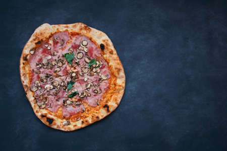 Delicious homemade pizza on black background