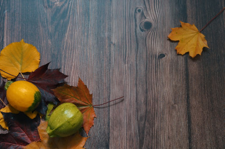 Directly above shot of pumpkins and autumn leaves on wooden backgroundの写真素材