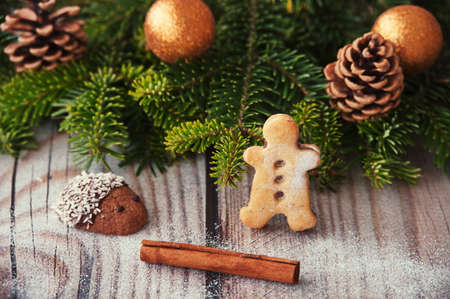 Christmas cookies and cinnamon with Christmas decoration on wooden backgroundの写真素材