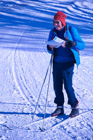 Portrait of senior man on skis in winter landscapeの写真素材