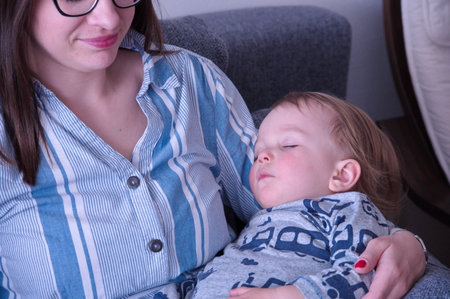 Mother holding her sleepy little boy