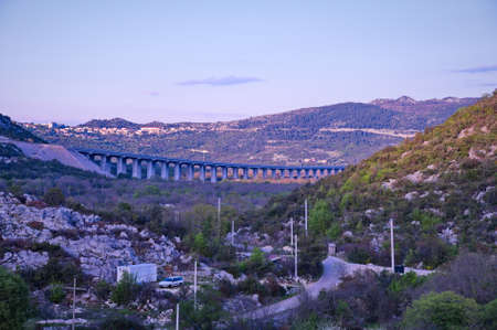 Viaduct across the valley with series of arches carrying a roadの写真素材