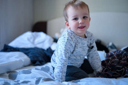 Portrait of cute toddler on the bed