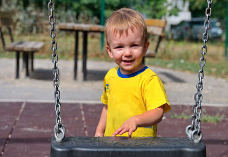 Portrait of sweet little boy on playgroundの写真素材