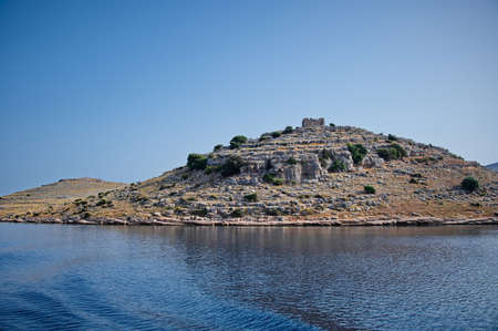 Island in Adriatic sea with ancient fort on the hillの写真素材