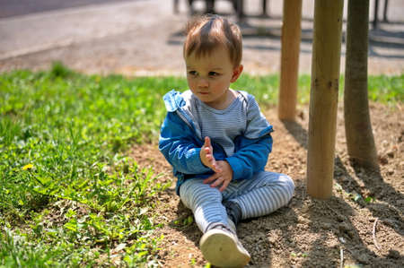 Portrait of sweet little boy in the parkの写真素材