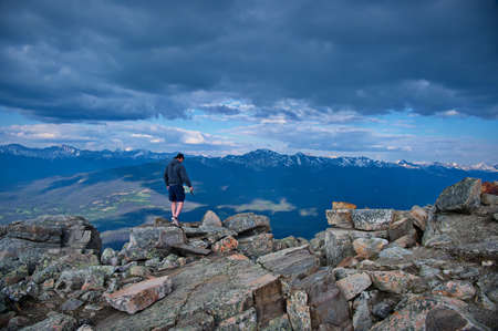 Mature man on the edge of the cliffの写真素材